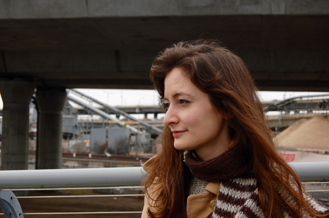 Profile portrait of Madeleine in front of concrete overpasses